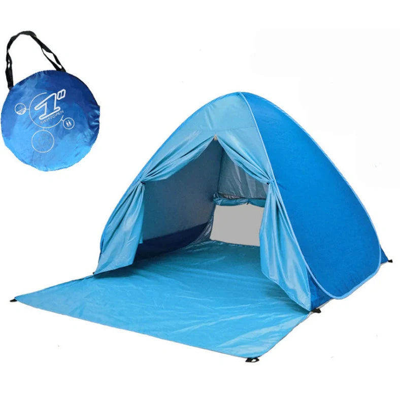 Blue automatic pop-up camping tent fully deployed showing interior space and round storage bag