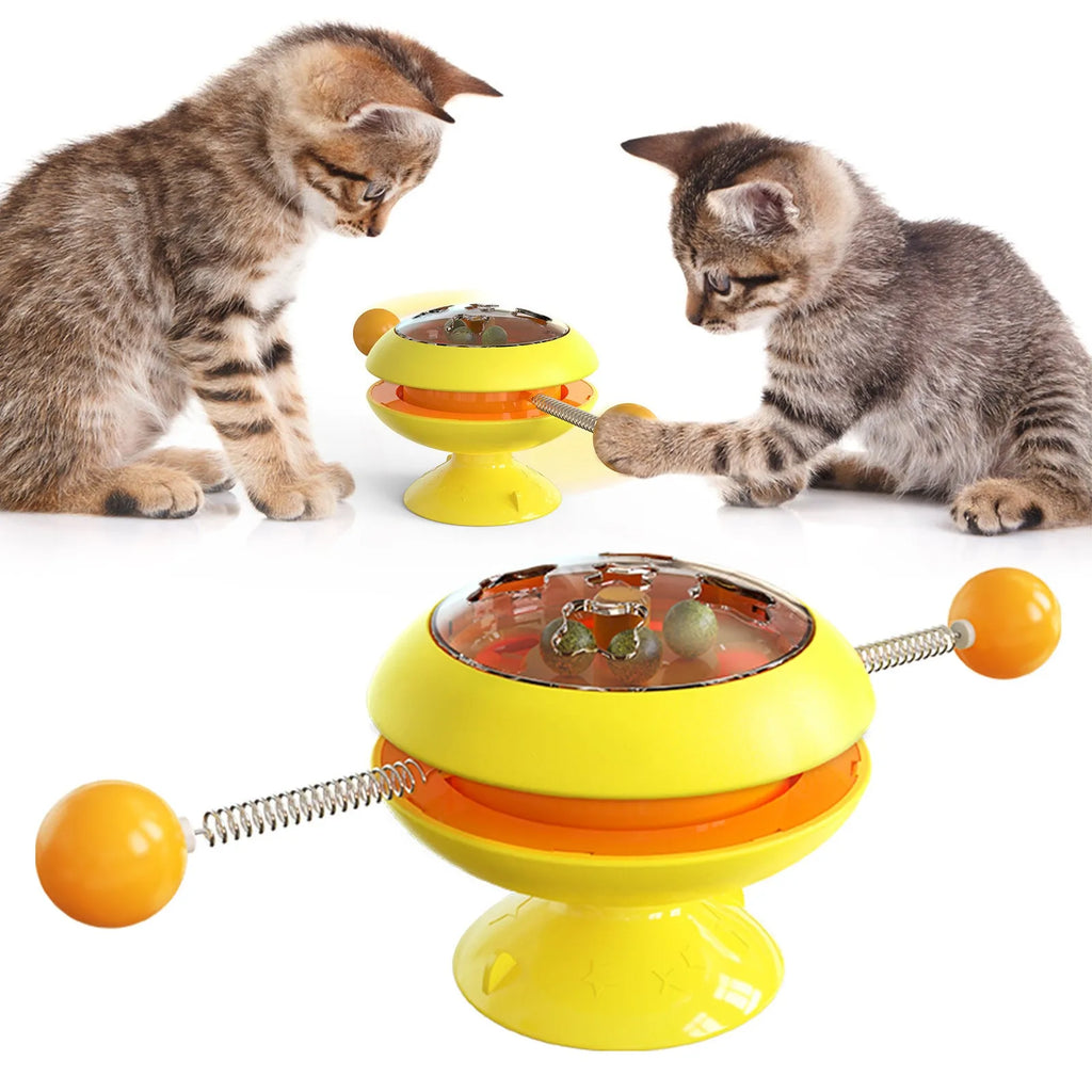 Rotatable cat toy with transparent top containing catnip balls and suction cup base