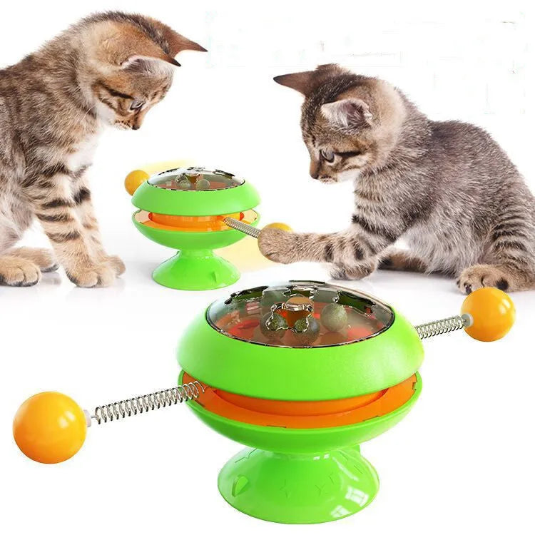 Rotatable cat toy with transparent top containing catnip balls and suction cup base