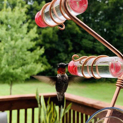 Handcrafted copper wire hummingbird feeder with transparent PET bottles for easy nectar monitoring, perfect for Kiwi gardens