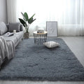 Nordic fluffy plush rectangular carpet with anti-slip base in beige colour on wooden floor