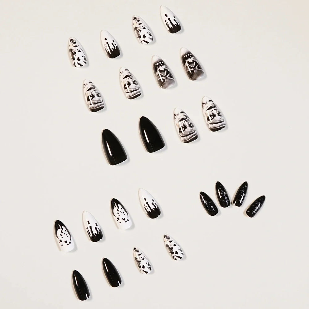 Black acrylic fake nails with white skull designs, 24 pieces displayed on packaging