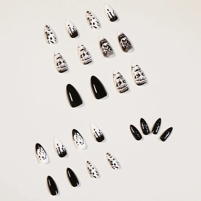 Black acrylic fake nails with white skull designs, 24 pieces displayed on packaging