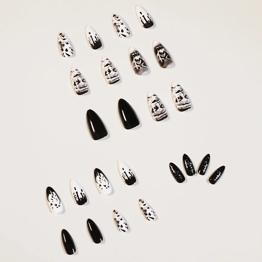Black acrylic fake nails with white skull designs, 24 pieces displayed on packaging
