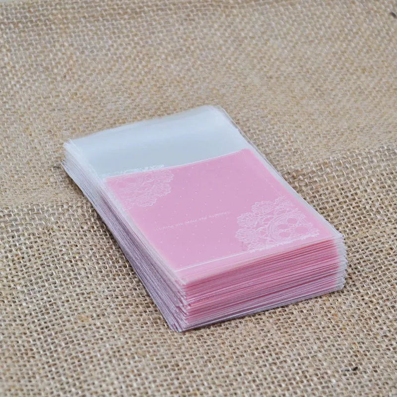Pink self-adhesive plastic packaging bag for handmade soap with a gusseted side.