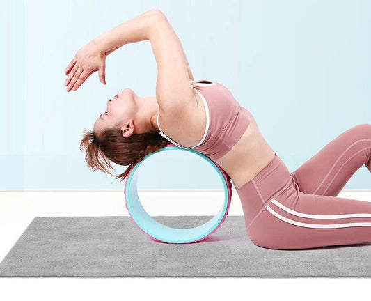 Purple yoga wheel with massage point surface measuring 113cm long and 32cm diameter for muscle relaxation