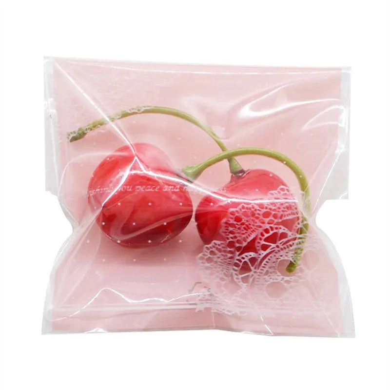 Pink self-adhesive plastic packaging bag for handmade soap with a gusseted side.