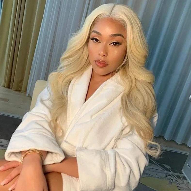 Blonde Brazilian body wave human hair wig with transparent lace front and pre-plucked hairline, showing 68cm length waves