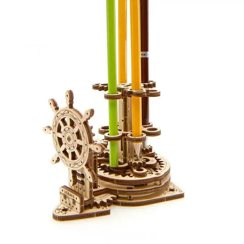 Ukrainian wooden rotating model pen holder on a desk.