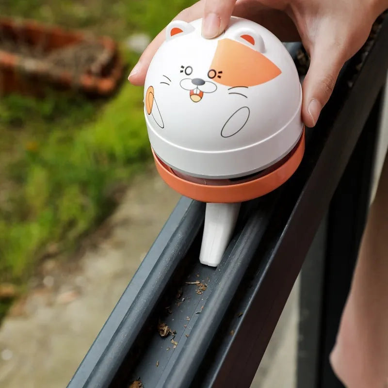 Handheld grey and orange USB mini vacuum cleaner with flat nozzle for cleaning keyboards and desktops.
