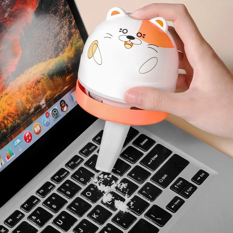 Handheld grey and orange USB mini vacuum cleaner with flat nozzle for cleaning keyboards and desktops.
