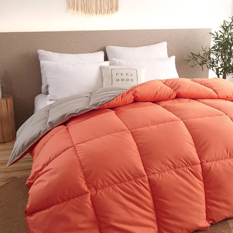 Goose down winter duvet with twill weave fabric in multiple colour options on a bed.
