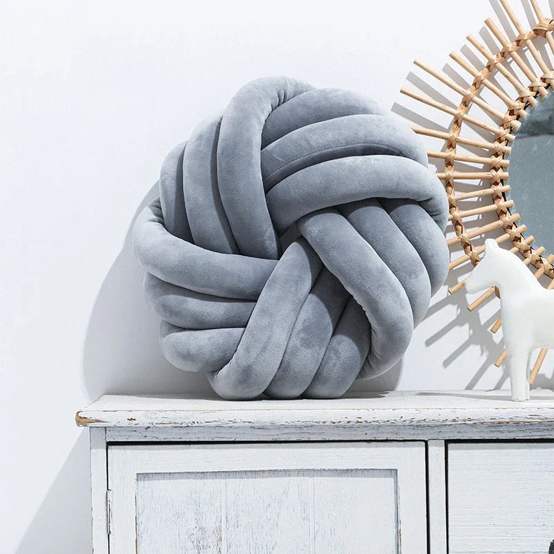 Decorative Nordic throw pillows in various colors, featuring a unique knotted ball design for a cozy and stylish living room or home decor accent.