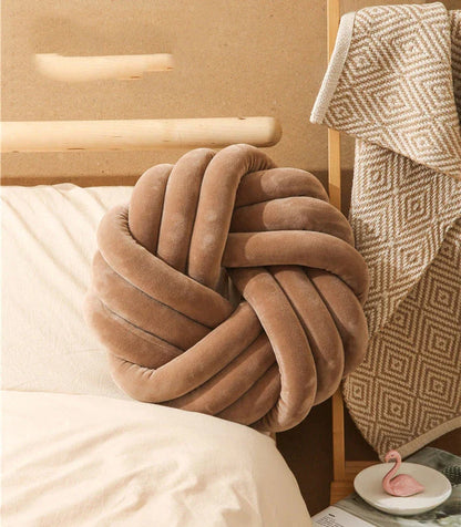 Decorative Nordic throw pillows in various colors, featuring a unique knotted ball design for a cozy and stylish living room or home decor accent.