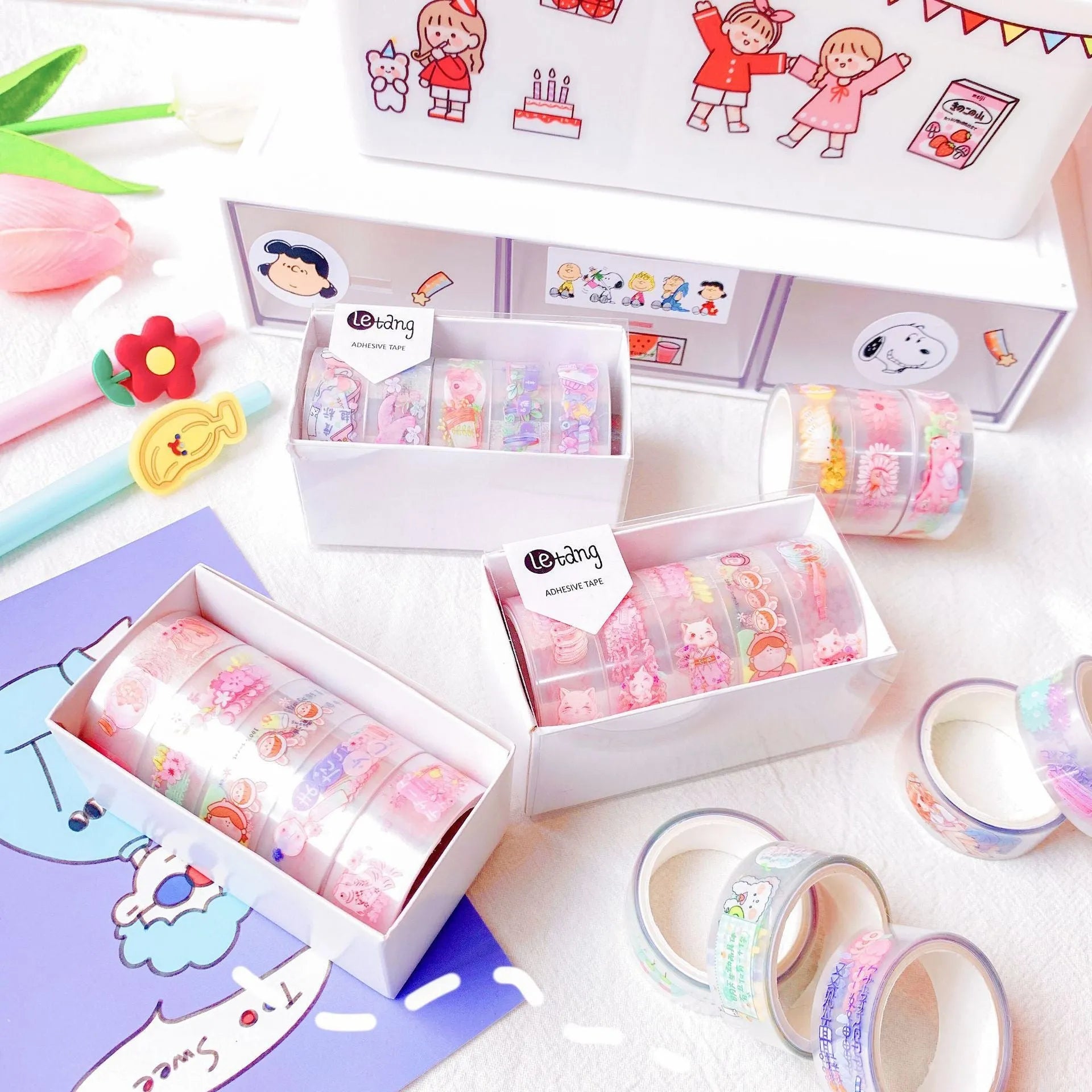 Five rolls of decorative washi tape showing dinosaur, duck, rabbit, and lucky cat designs for craft projects