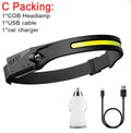 Black silicone induction fishing light with touch switch, shown with USB charging cable and strap.