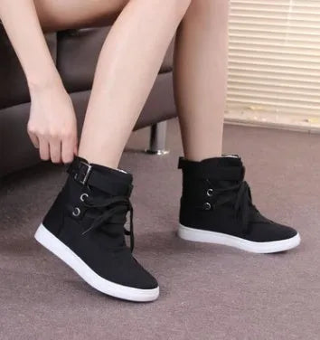 Women's black canvas casual shoes with cross strap detail, flat heel, and lace-up closure on a plain background.