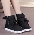 Women's black canvas casual shoes with cross strap detail, flat heel, and lace-up closure on a plain background.