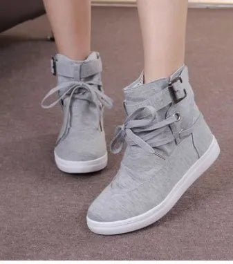 Women's black canvas casual shoes with cross strap detail, flat heel, and lace-up closure on a plain background.
