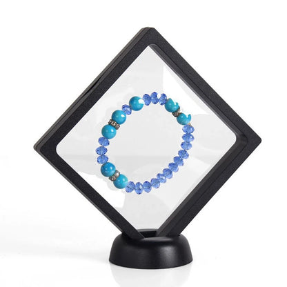 3D floating jewelry display stand showcasing earrings and coins in mid-air