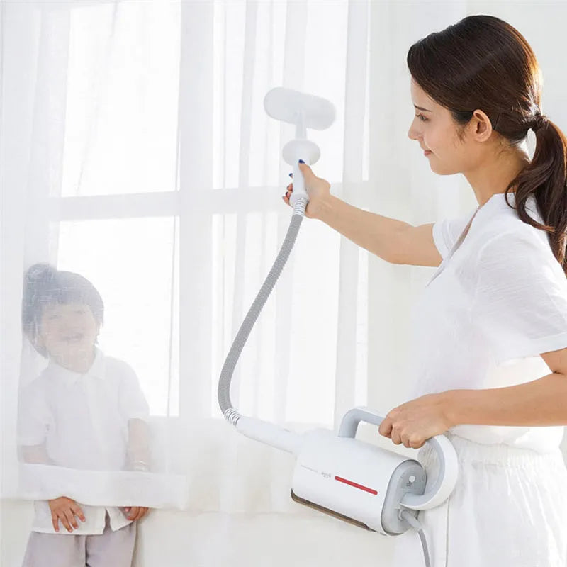 Deerma DEM-ZQ610 white steam cleaner main unit with brush heads, mop, and extension tubes on a floor.