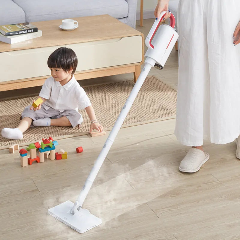 Deerma DEM-ZQ610 white steam cleaner main unit with brush heads, mop, and extension tubes on a floor.