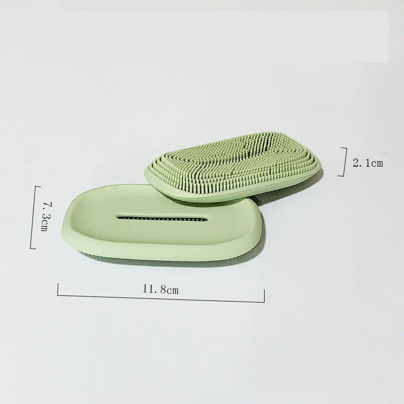 Versatile silicone soap holder with attached cleaning brush, available in a range of Kiwi-inspired Nordic colours and shapes