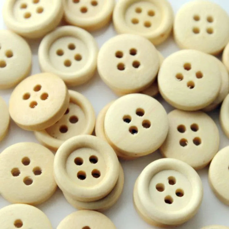 Round natural wood buttons in various sizes 10mm to 30mm on a white background concave flower design