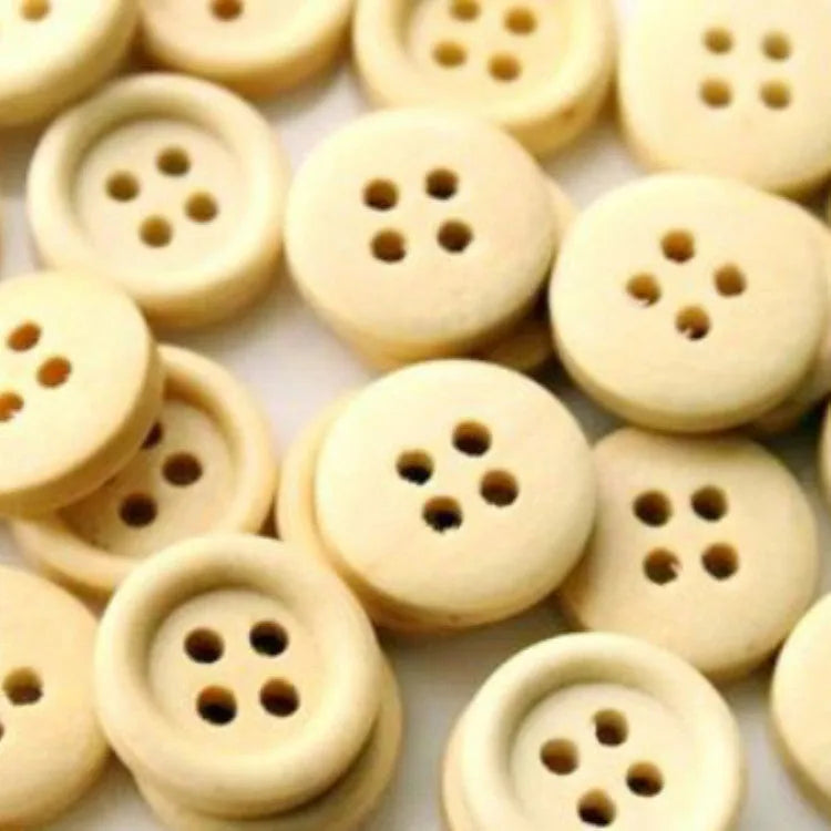Round natural wood buttons in various sizes 10mm to 30mm on a white background concave flower design