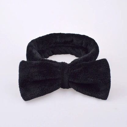 Coral velvet butterfly end hair band in pink with text styling, showing butterfly ends and cloth material