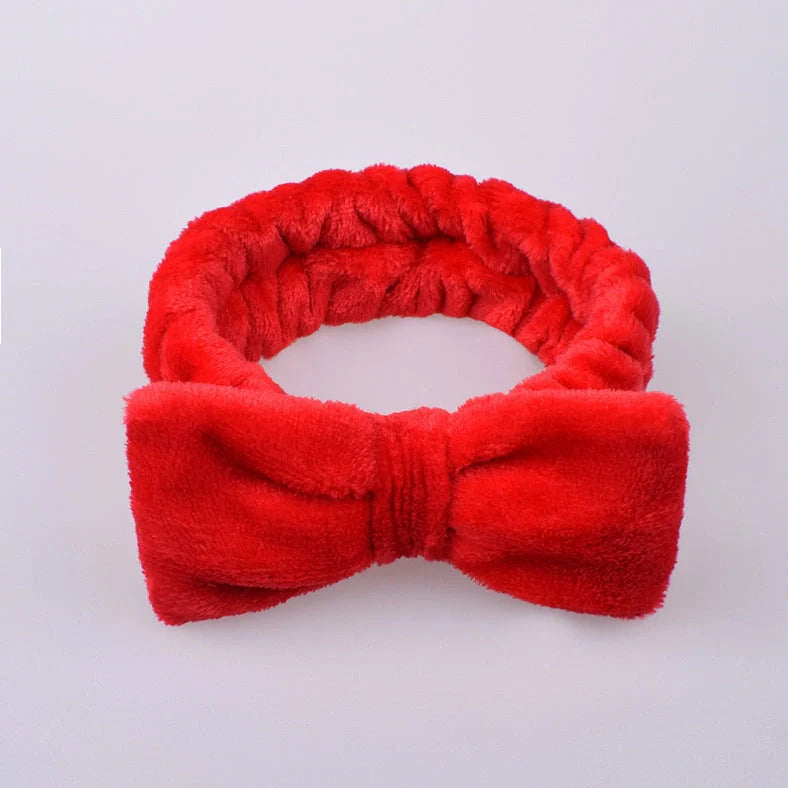 Coral velvet butterfly end hair band in pink with text styling, showing butterfly ends and cloth material