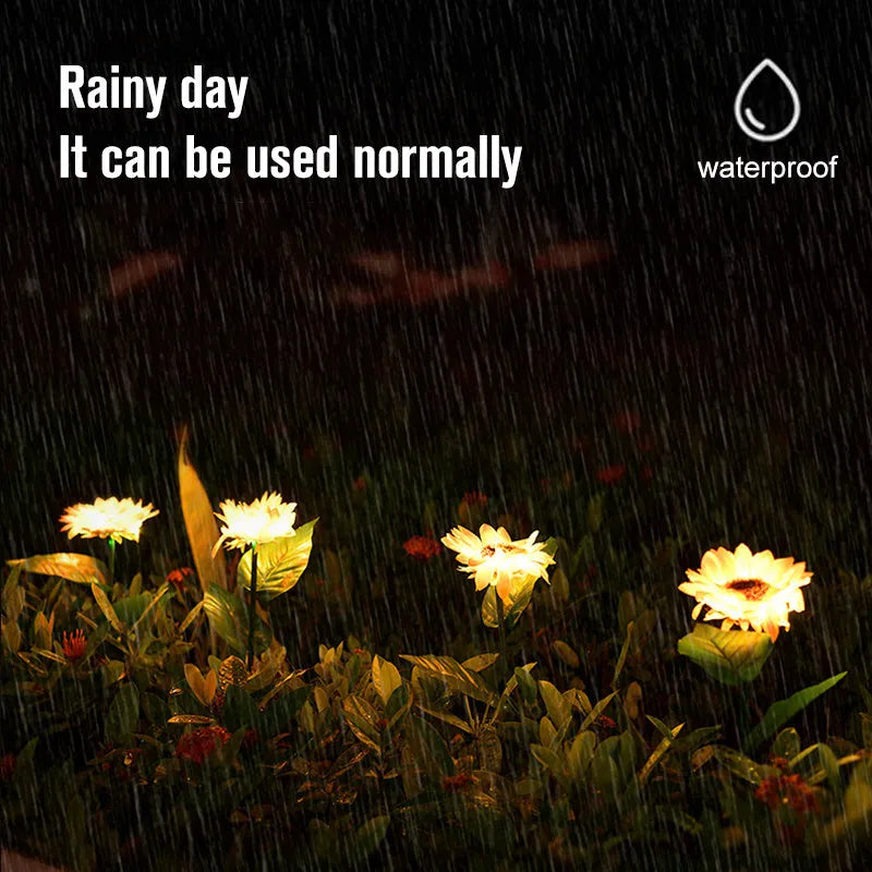 Yellow LED solar sunflower lamp on a lawn with a 66cm stem and 15cm flower head