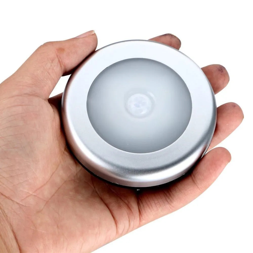 Silver or black wireless motion sensor night light with a square PC plastic lampshade.