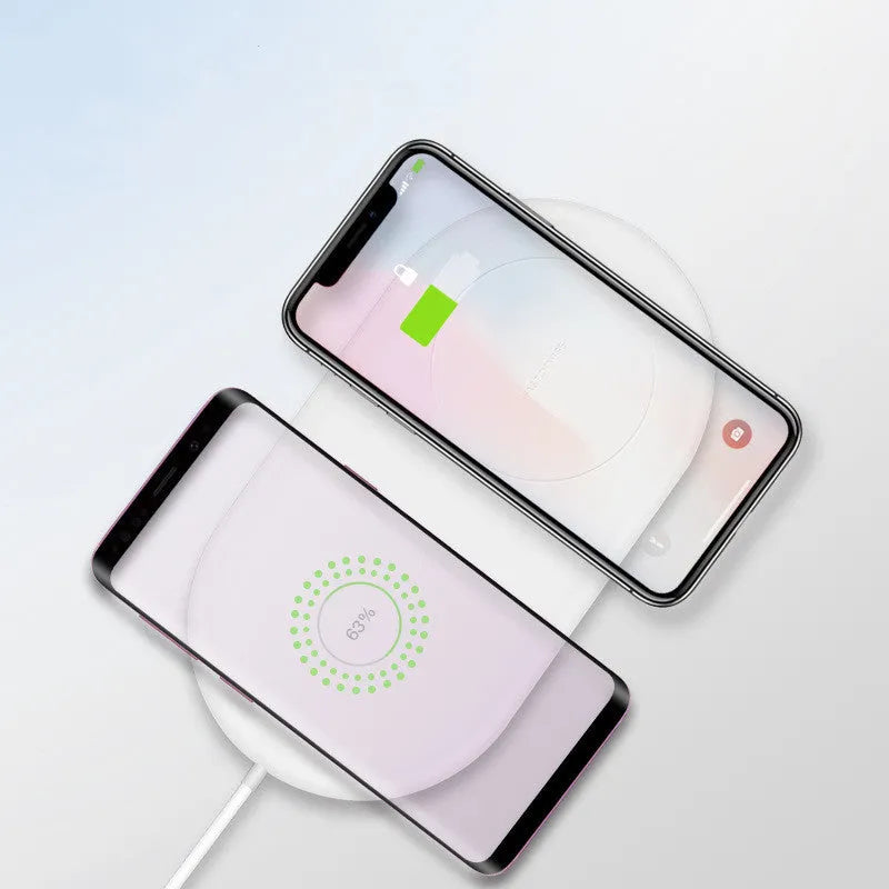 White dual wireless charging station for two mobile phones on a minimalist base.