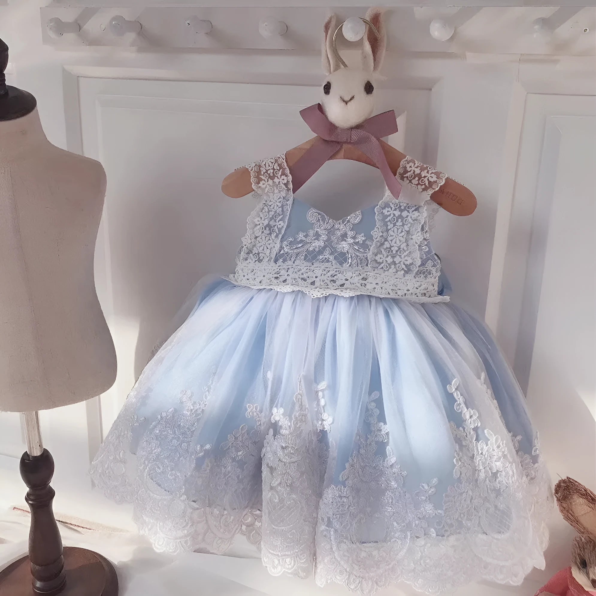 Ocean blue princess dress for baby girls with lace detailing, shown on hanger