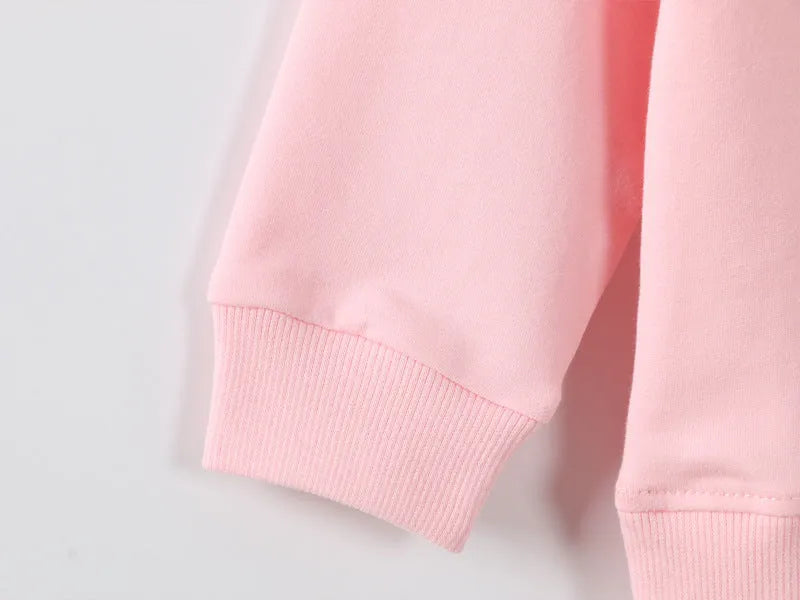 Baby girl wearing a soft, cartoon-print Korean-style sweatshirt for autumn.