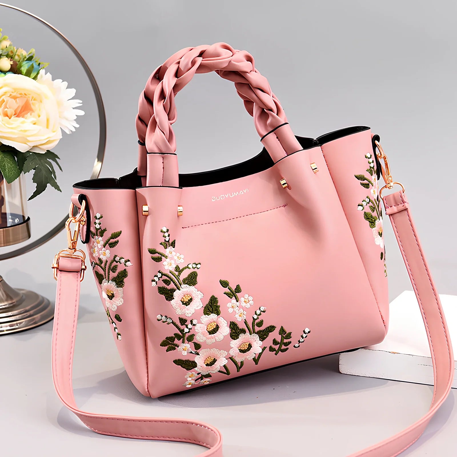 Women's medium tote bag with drawstring closure in PU leather, showing car stitching details