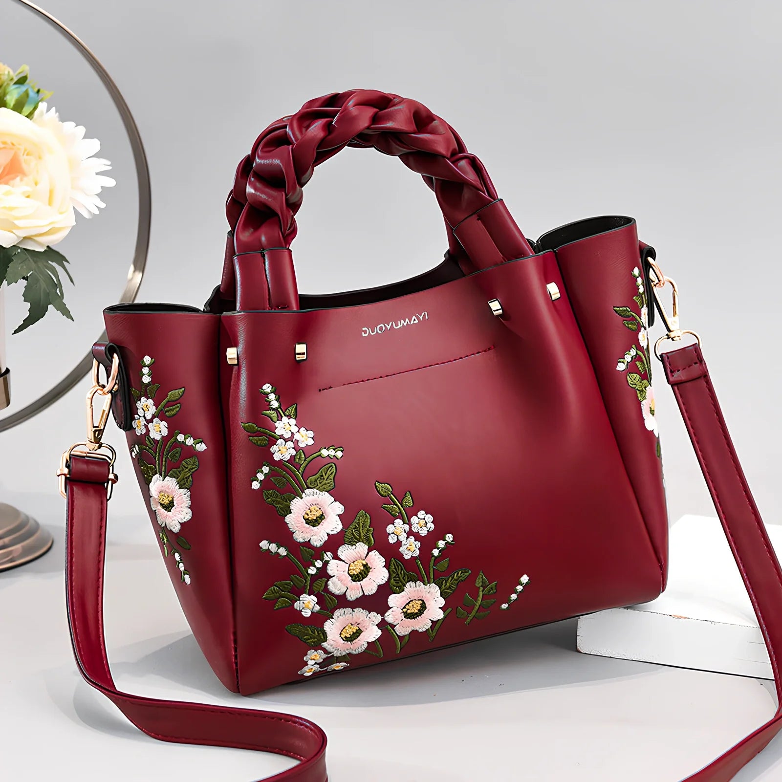 Women's medium tote bag with drawstring closure in PU leather, showing car stitching details