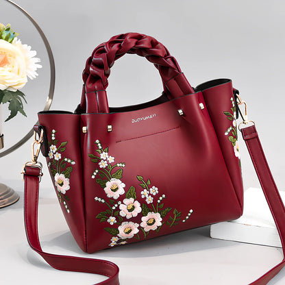 Women's medium tote bag with drawstring closure in PU leather, showing car stitching details