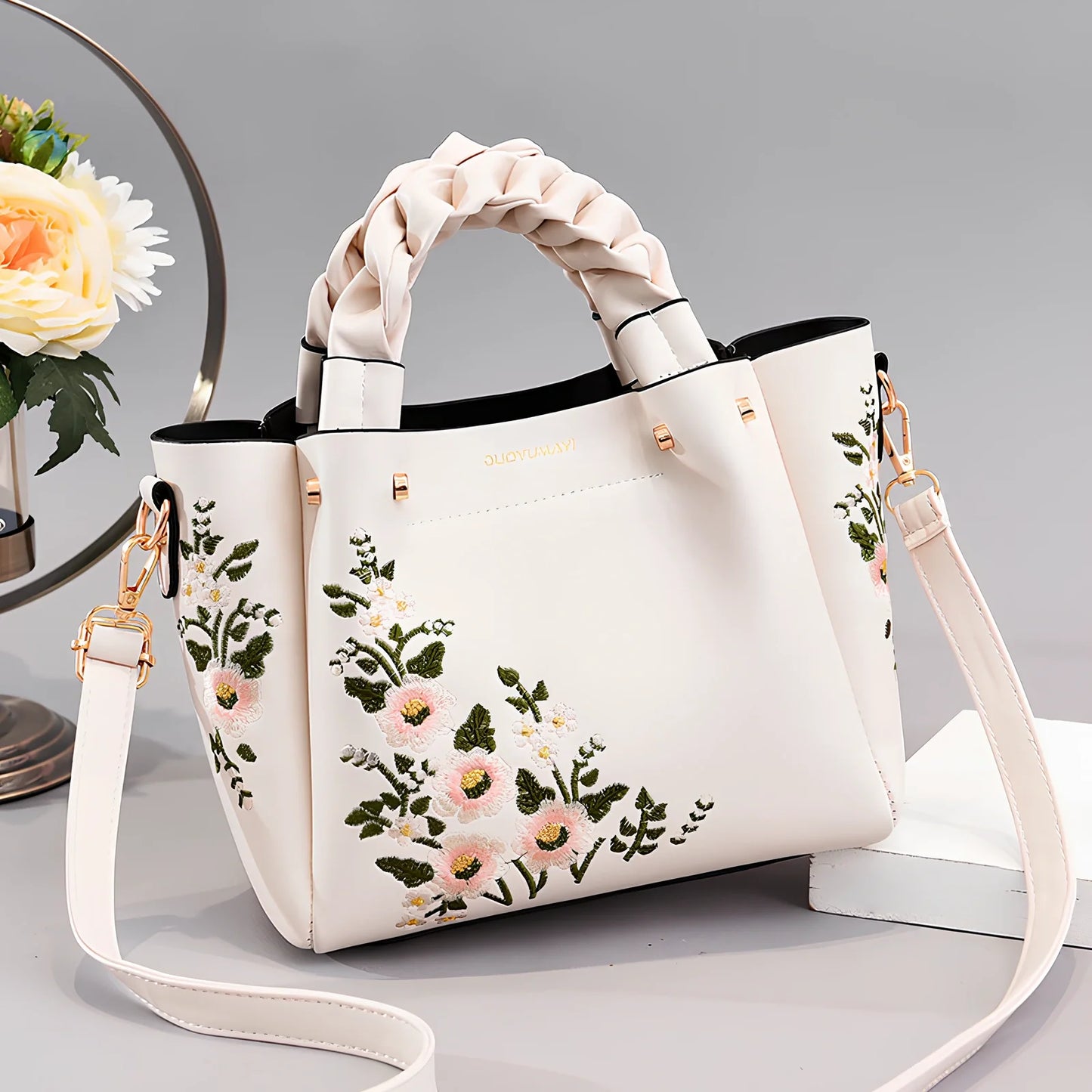 Women's medium tote bag with drawstring closure in PU leather, showing car stitching details