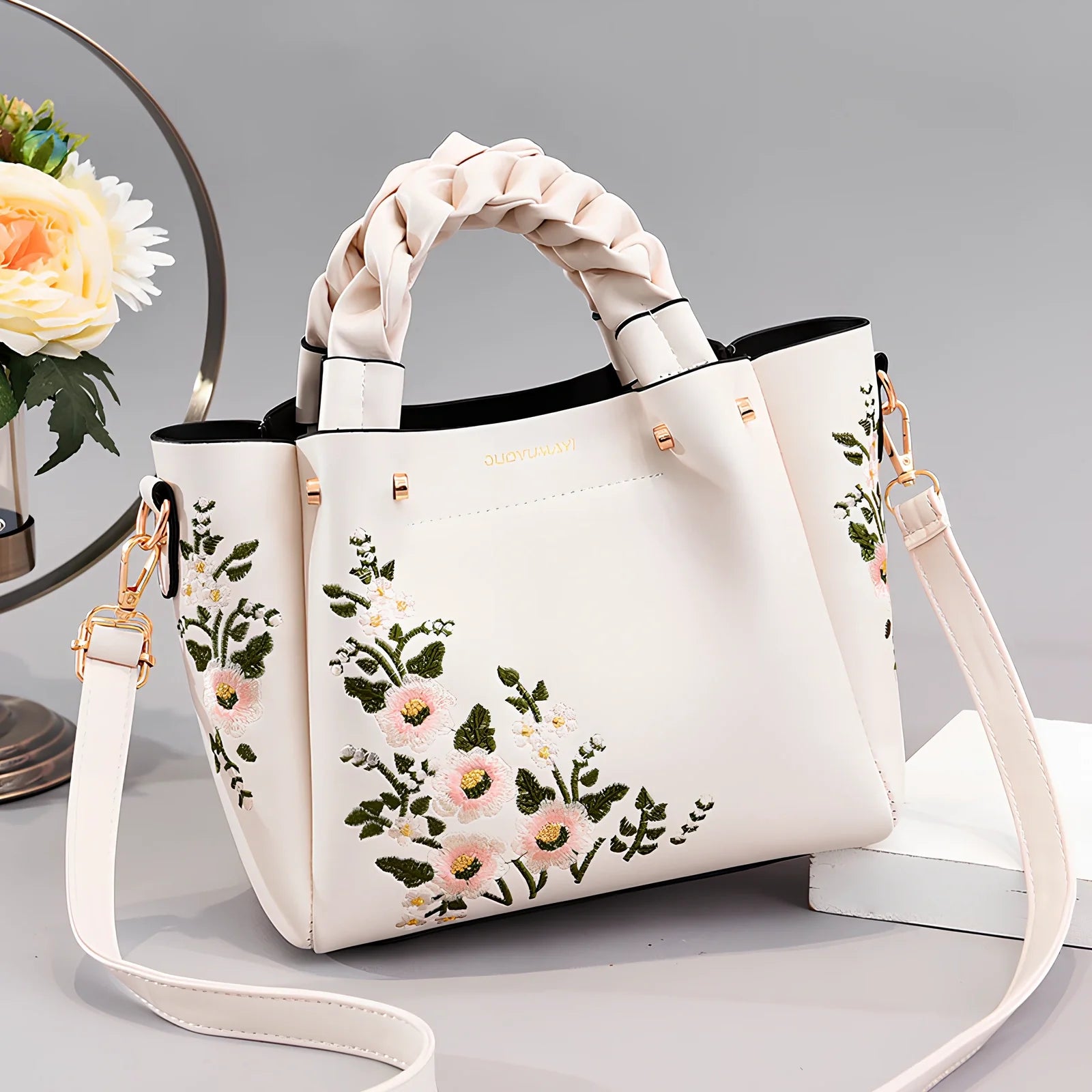 Women's medium tote bag with drawstring closure in PU leather, showing car stitching details