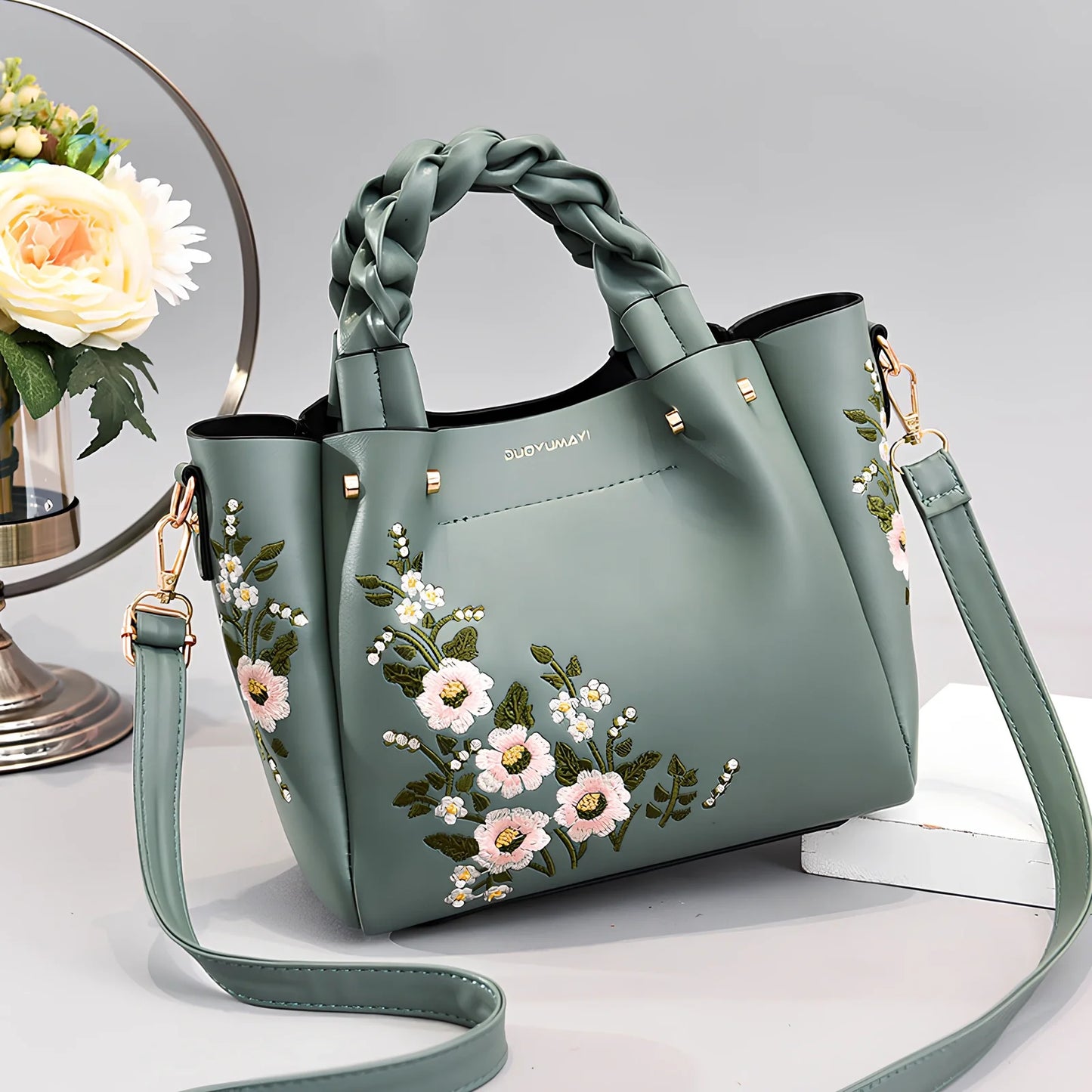 Women's medium tote bag with drawstring closure in PU leather, showing car stitching details