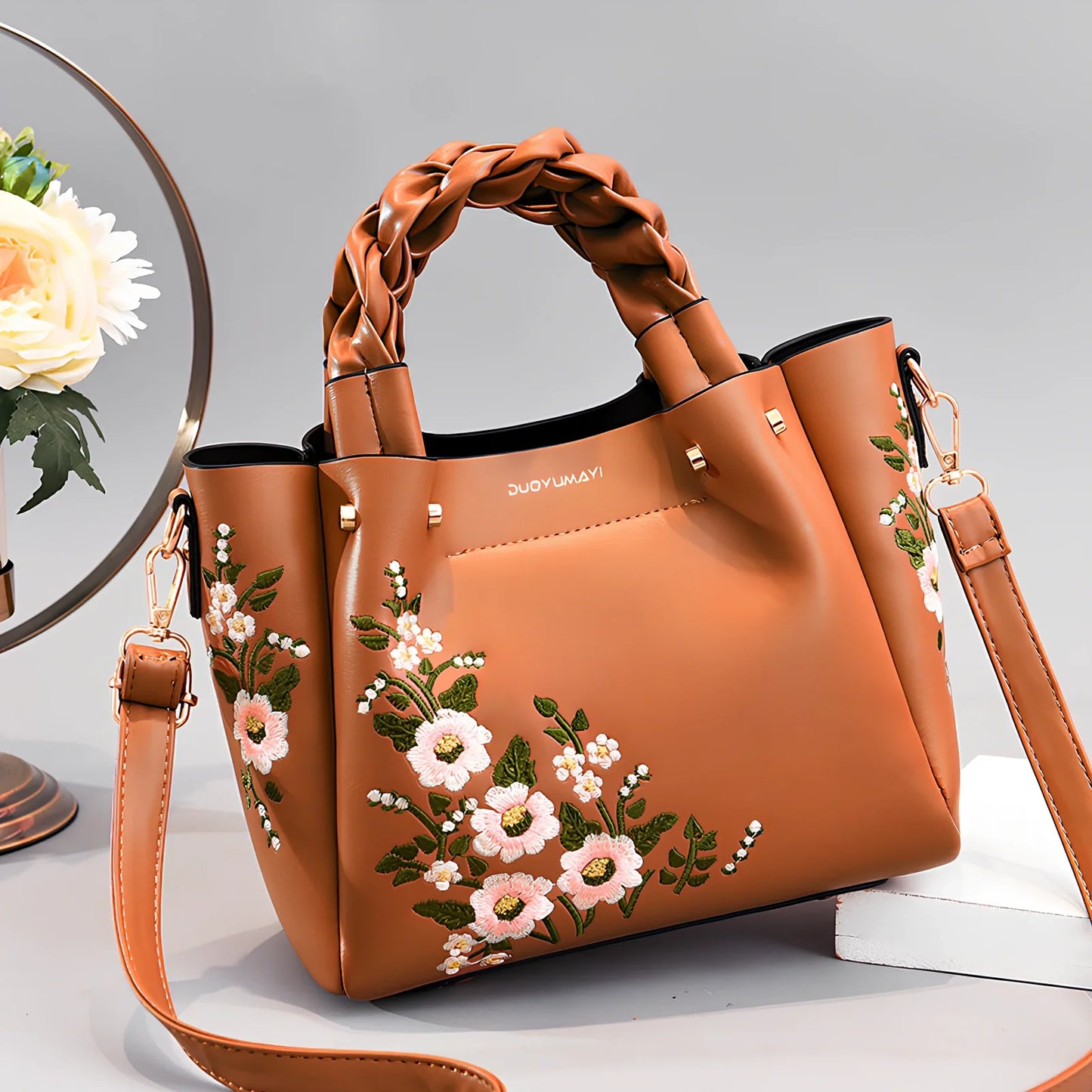 Women's medium tote bag with drawstring closure in PU leather, showing car stitching details