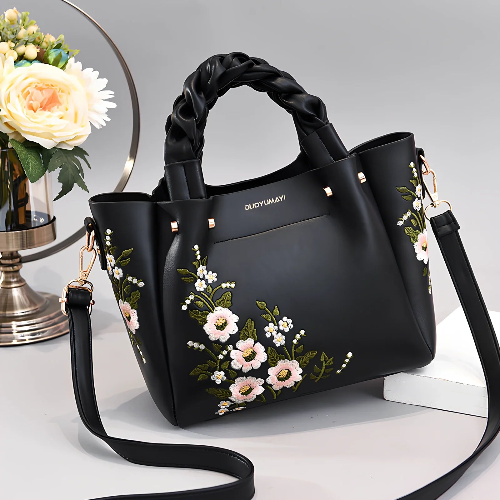 Women's medium tote bag with drawstring closure in PU leather, showing car stitching details