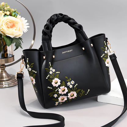 Women's medium tote bag with drawstring closure in PU leather, showing car stitching details