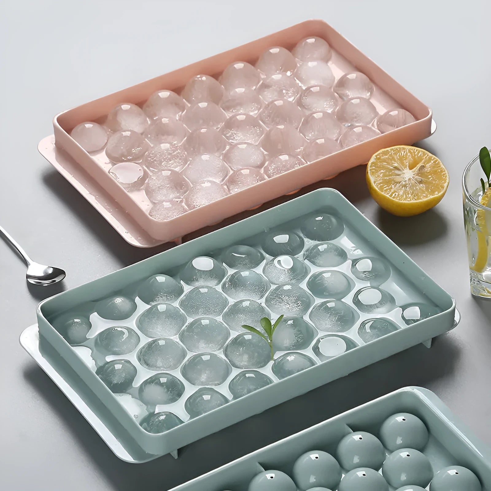 Sky blue and pink round ball ice cube trays showing 18 and 33 grid options