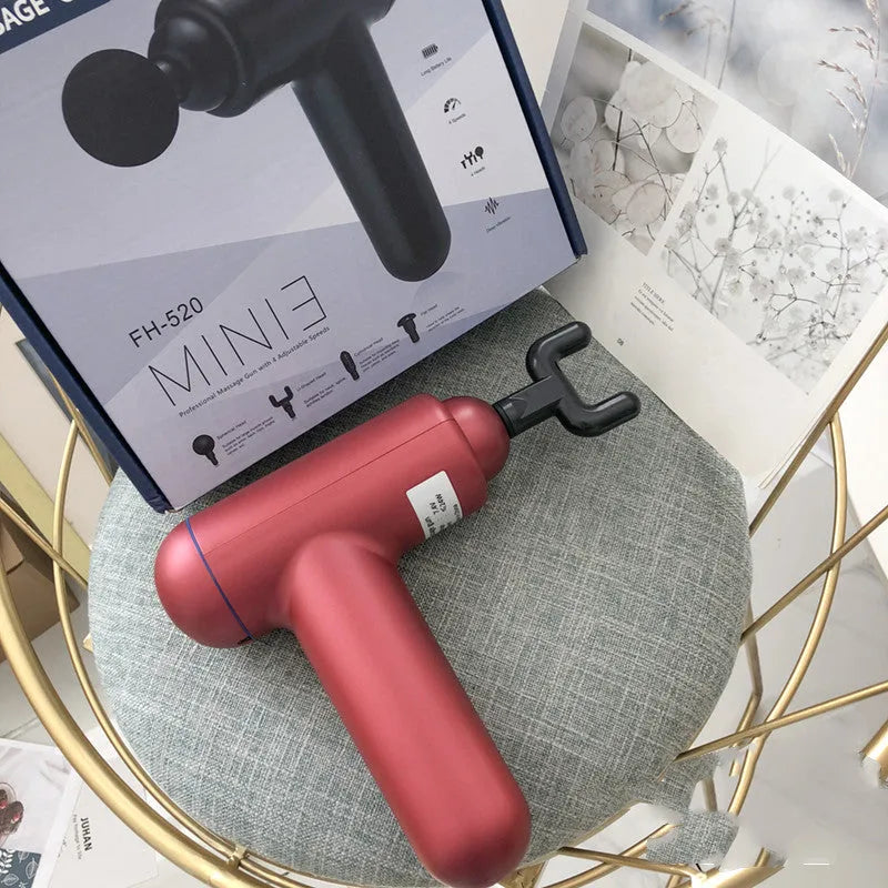 Grey, red, and black fascia massage gun with USB charging port.