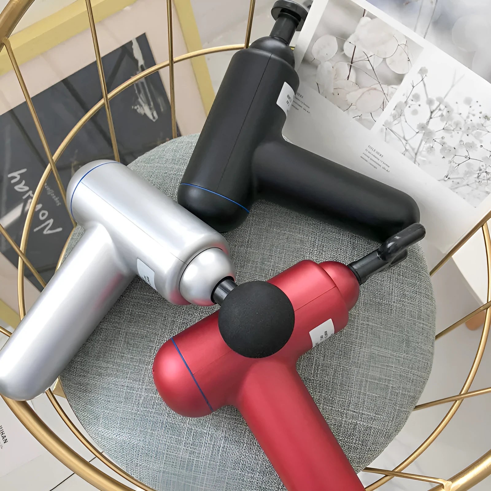 Grey, red, and black fascia massage gun with USB charging port.