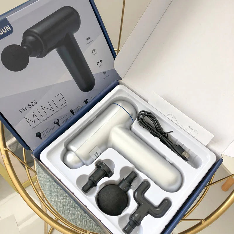Grey, red, and black fascia massage gun with USB charging port.
