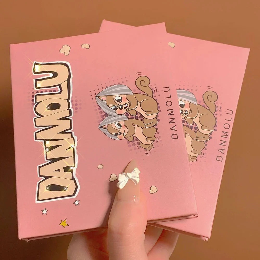 DANMOLU Shaved Mouse Eyeshadow Palette showing 12 colour pans in compact 15cm x 10cm case with dual-ended applicator